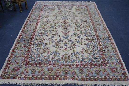 A Tabriz style cream ground carpet, woven with scattered flowers, 315 x 214cm